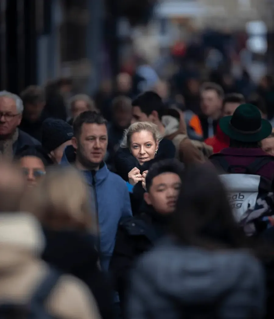 A woman standing out in a busy crowd